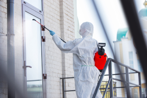 A remediation professional working in protective clothing